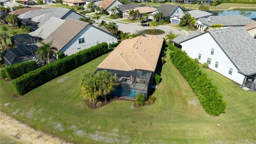 Aerial perspective of suburban area with a nearby body of water