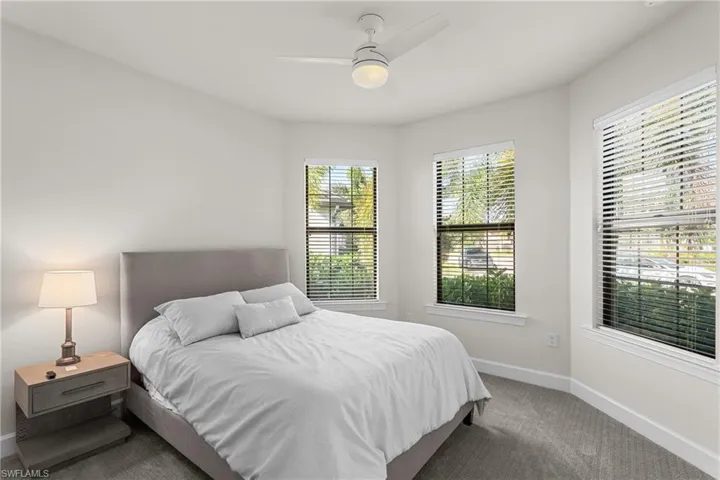 Bedroom featuring ceiling fan and carpet