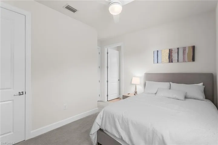 Bedroom featuring light carpet and ceiling fan