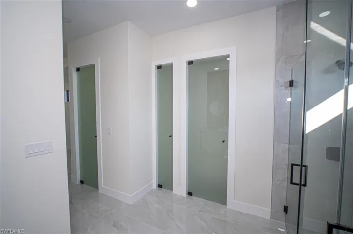 Bathroom featuring a stall shower and recessed lighting