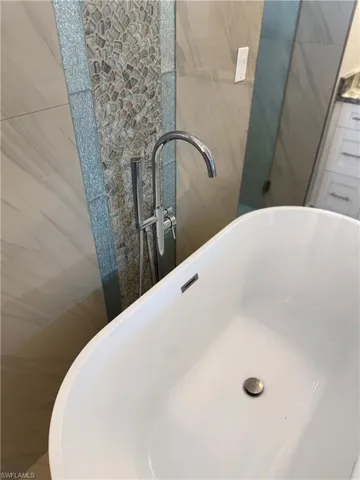 Bathroom view of a sink and a freestanding tub
