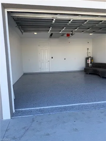Garage featuring electric water heater