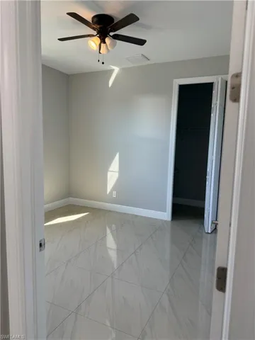 room 1 with baseboards and a ceiling fan