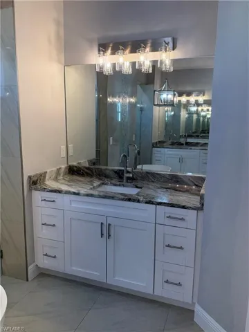 Bathroom featuring vanity and a shower stall