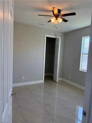 Unfurnished bedroom 3 with ceiling fan and a closet