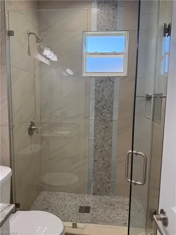 Full bath 1 with toilet and a shower stall