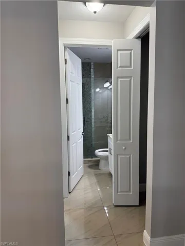 View of corridor with shared bathroom