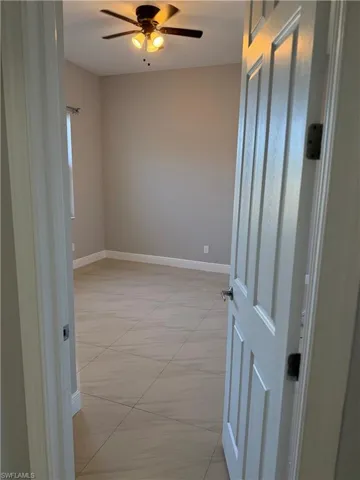 Unfurnished room 2 with baseboards and ceiling fan