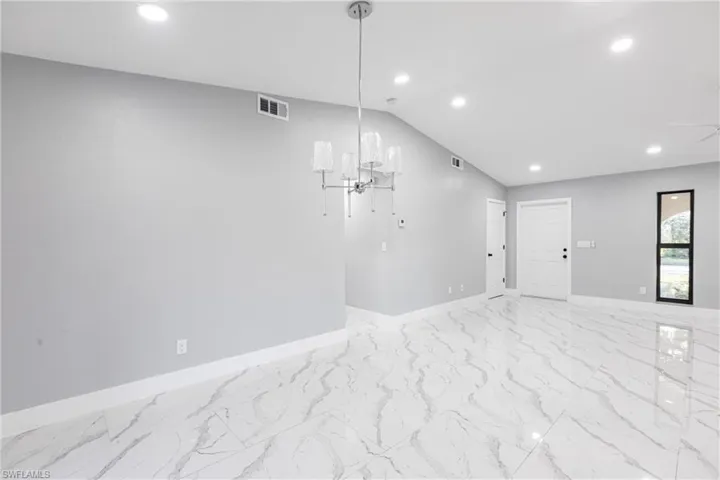 Spare room featuring marble finish floor, baseboards, visible vents, and recessed lighting