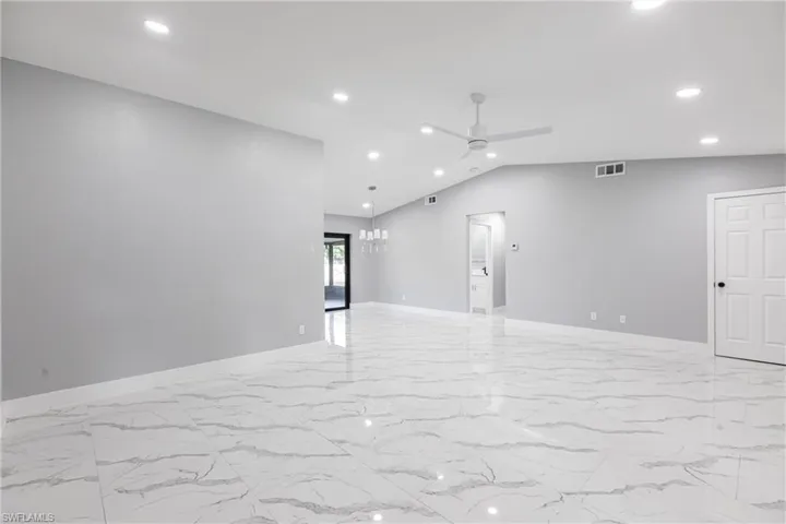 Empty room featuring recessed lighting, marble finish floor, visible vents, a ceiling fan, and baseboards