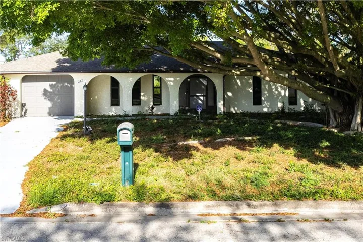 View of front of property featuring concrete driveway, a shingled roof, covered porch, an attached garage, and stucco siding