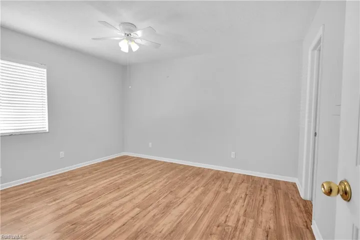Empty room with light wood-type flooring and a ceiling fan