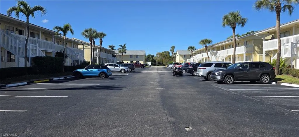 Uncovered parking lot featuring a residential view