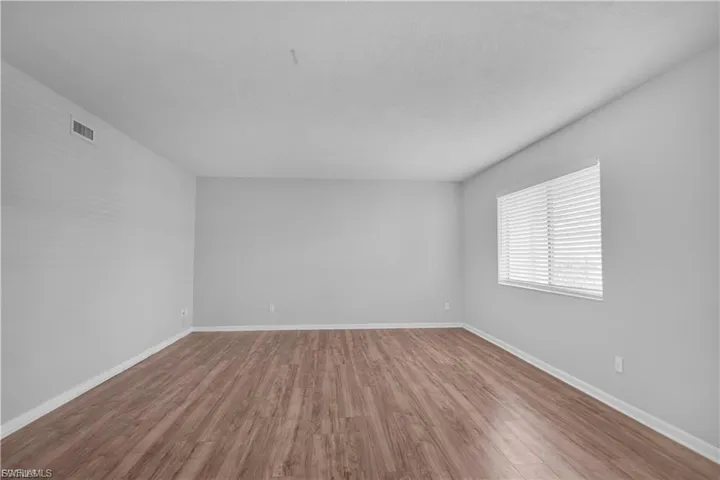 Empty room featuring baseboards and wood finished floors