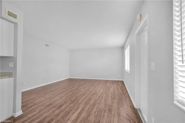 Empty room with wood finished floors and baseboards