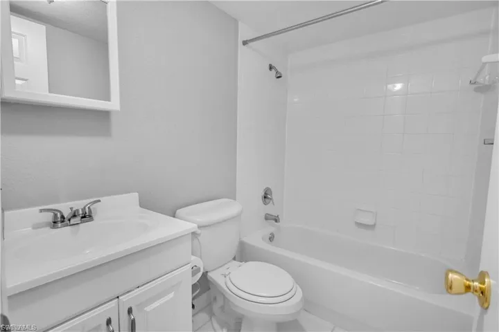 Full bath featuring vanity and shower / bath combination