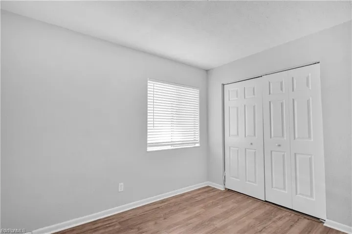 Unfurnished bedroom featuring light wood-type flooring and a closet
