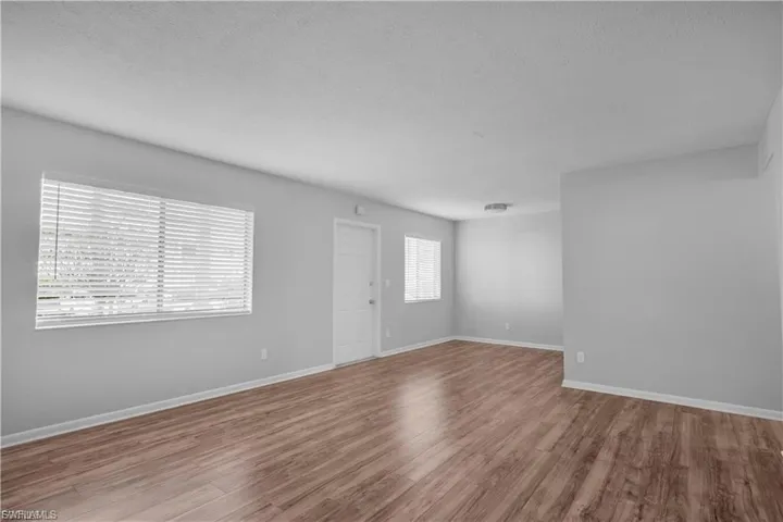 Empty room featuring wood finished floors and a textured ceiling