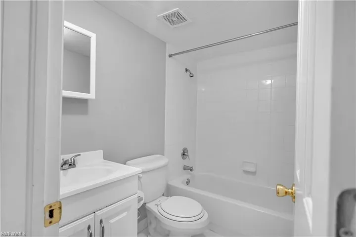 Full bathroom with shower / bath combination and vanity
