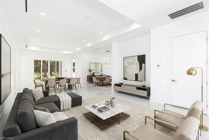Virtual staged - Living room featuring a raised ceiling and recessed lighting