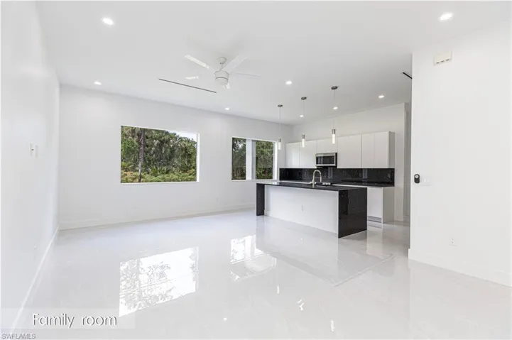 Kitchen featuring stainless steel microwave, modern cabinets, and recessed lighting
