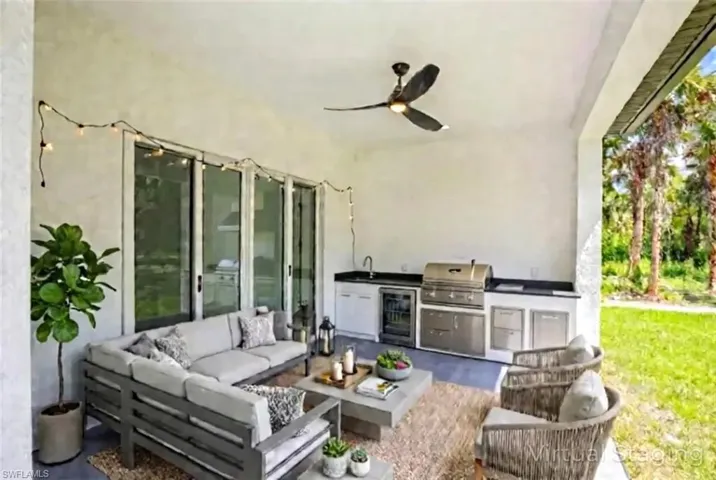 Virtual staged - View of patio / terrace with area for grilling, a ceiling fan, an outdoor hangout area, and wine cooler