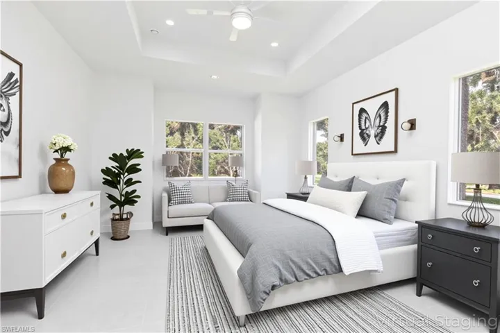 Virtual staged - Bedroom featuring ceiling fan, a raised ceiling, and recessed lighting
