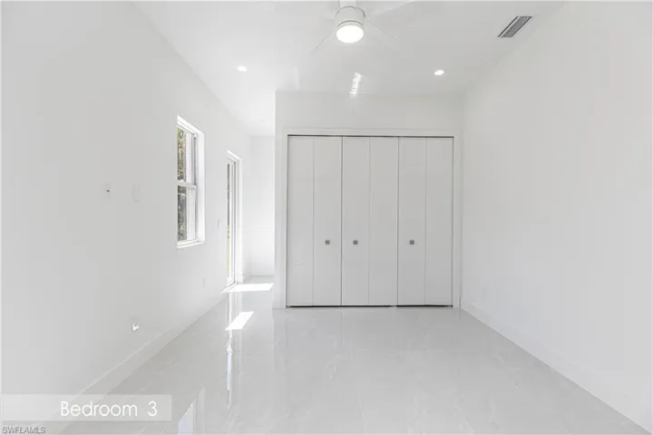 Unfurnished bedroom featuring a closet, recessed lighting, visible vents, and marble finish floor