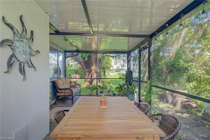 Sunroom featuring outdoor dining space