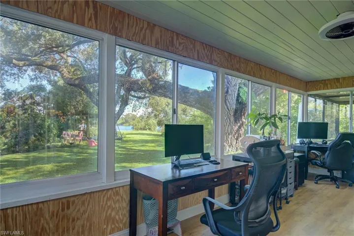 Office area with wood finished floors, wooden walls, and wood ceiling
