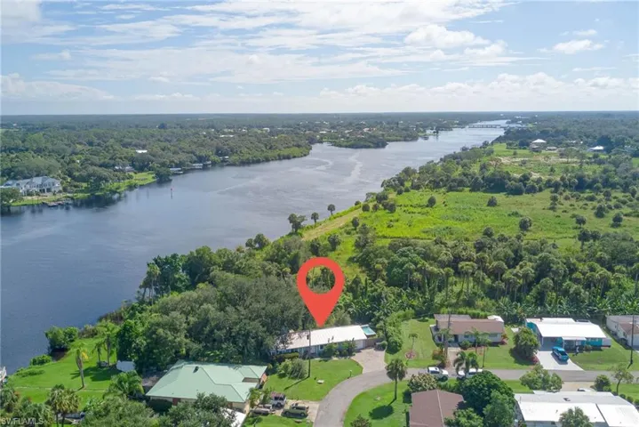 View of property location featuring a nearby body of water and a forest