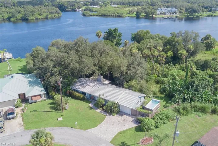 Aerial view of property and surrounding area featuring a large body of water