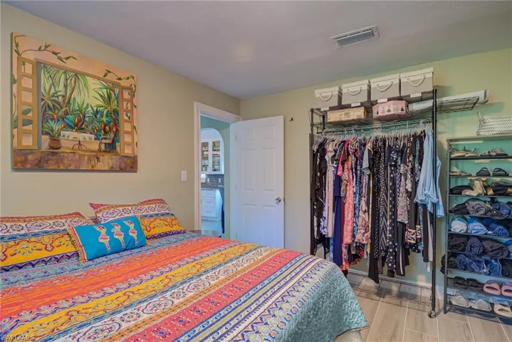 Bedroom with light wood-style floors and a closet