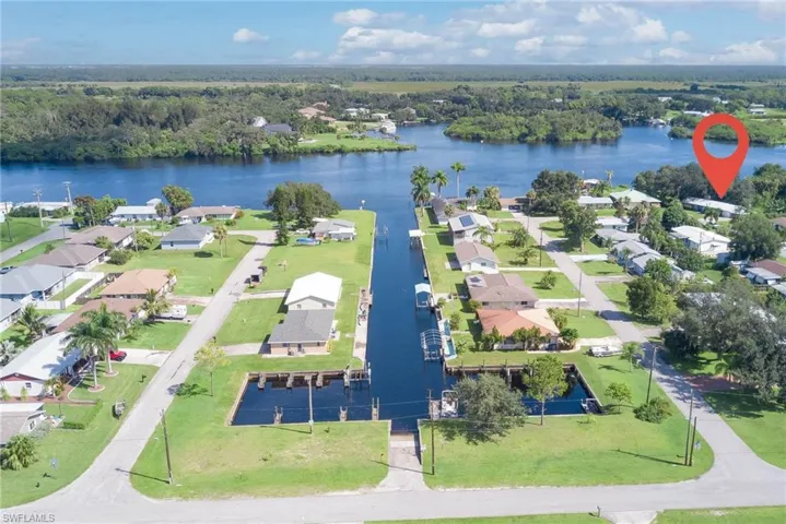 Aerial perspective of suburban area featuring a nearby body of water