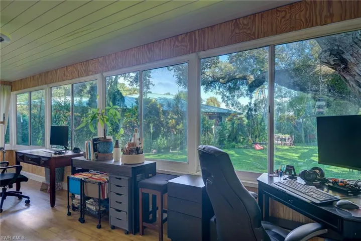 Office featuring wood finished floors and view of scattered trees