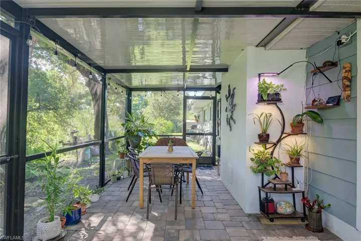 Sunroom / solarium with outdoor dining space