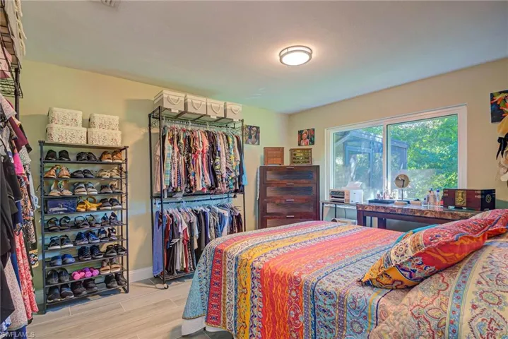 Bedroom featuring a closet and wood finish floors