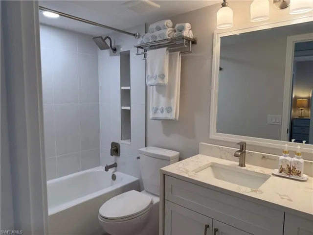 Bathroom featuring bathtub / shower combination and vanity