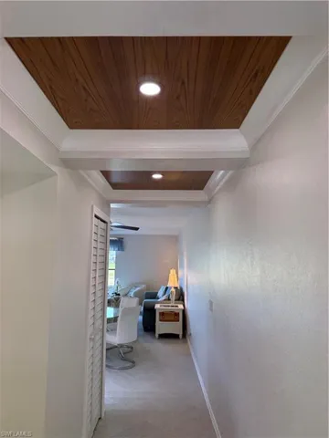 Hall featuring wooden ceiling, recessed lighting, and ornamental molding