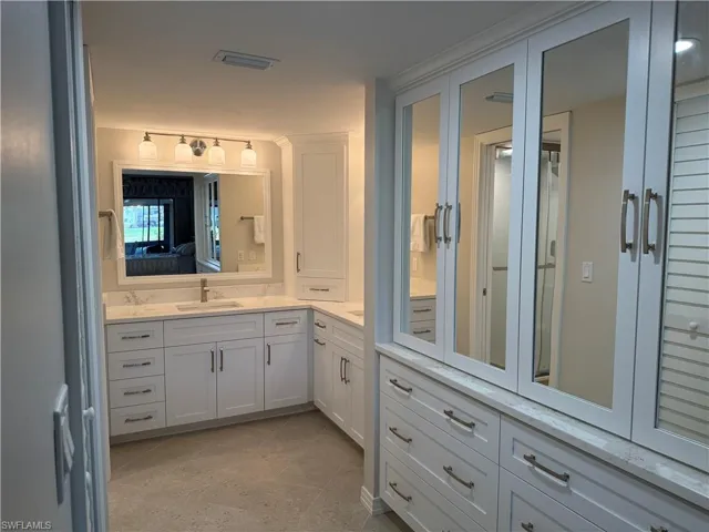 Ensuite bathroom featuring vanity and light tile patterned floors