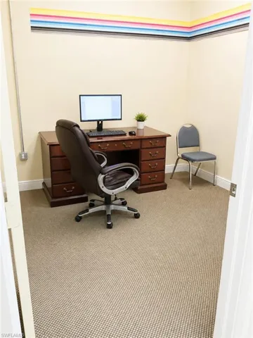 Carpeted room with light-toned walls and white baseboards