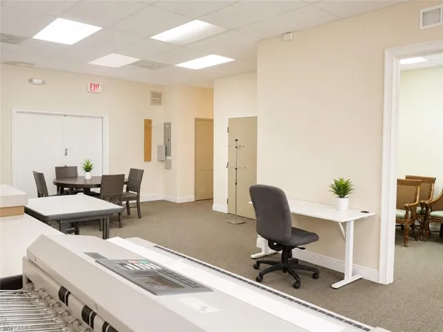 Open common area with neutral carpet flooring and white painted walls