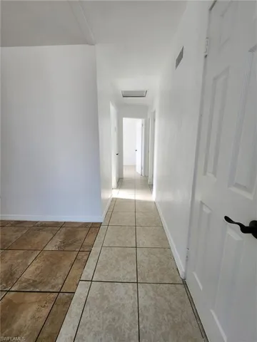 Hallway with light tile floors