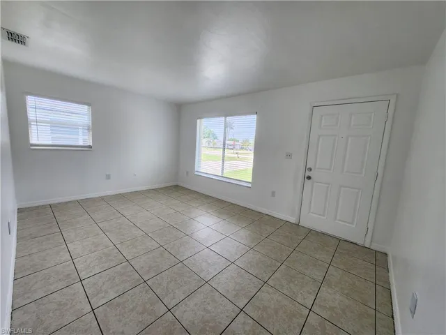 Living room featuring light tile floors