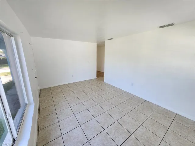 Living room featuring light tile floors