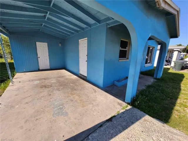 View of exterior entry with a yard
