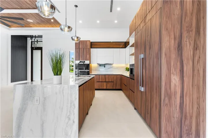 Top-of-the-line CUSTOM CABINETRY, under- & top-cabinet lights, natural stone countertops.