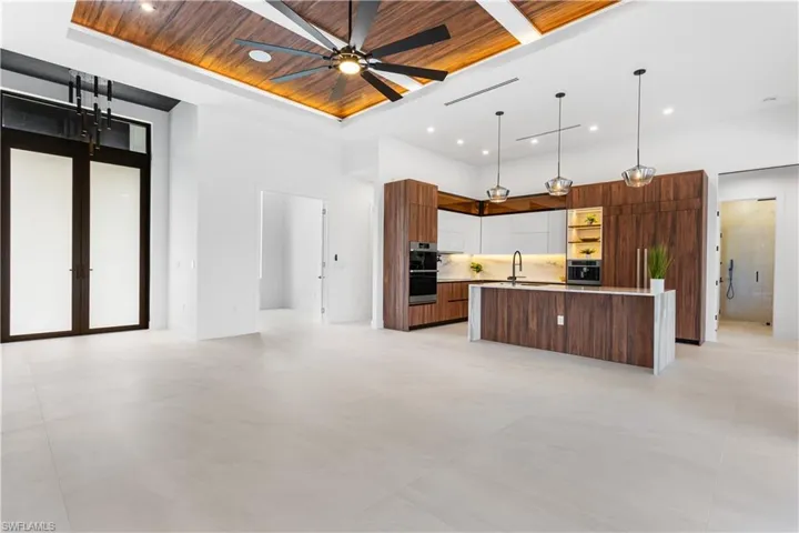 Open layout features minimal interior walls, creating a spacious, seamless flow between living areas, enhancing light and interaction within the space.