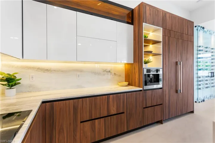 LUXURY APPLIANCES, including FULGOR MILANO BUILT-IN COFFEE MACHINE, DACOR wall oven & microwave, induction cooktop, integrated dishwasher & CUSTOM BUILT-IN SIDE-BY-SIDE REFRIGERATOR, elevating PERFORMANCE to new heights!