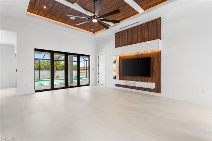AWE-INSPIRING LIVING ROOM w/ 16-foot COVE CEILING w/ FLAT WOODEN OVERHEADS & BEAMS.